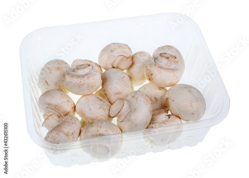 Whole fresh champignon mushrooms in blue plastic container isolated macro