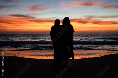 silhouette of a person on the beach at sunset