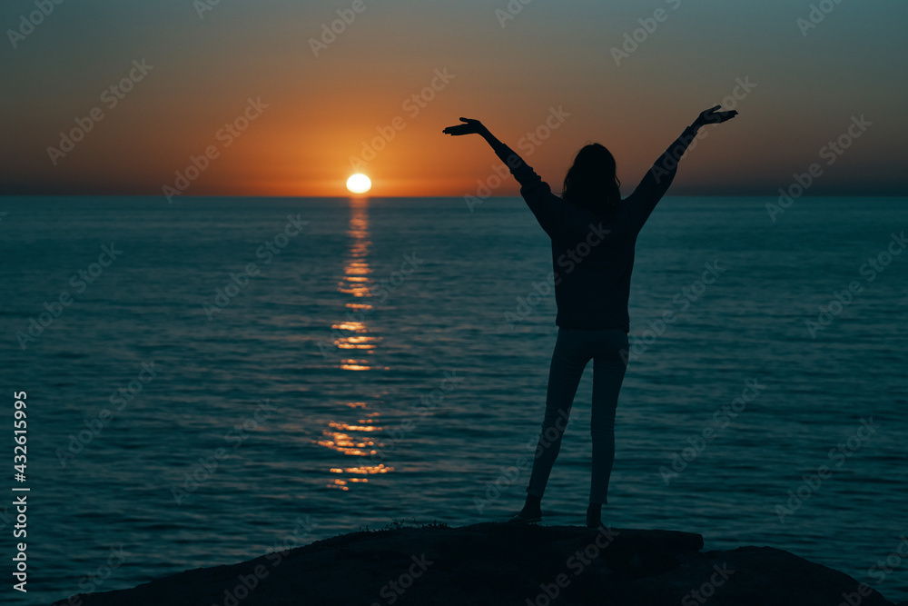 female silhouette gesturing with hands sunset sea model