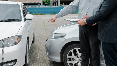 Loss Adjuster Insurance Agent Inspecting Damaged Car. .Sales manager giving advice application form document considering mortgage loan offer for car  insurance © Charlie's