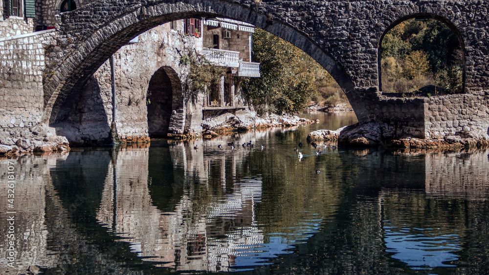 Montenegro - The ancient arched stone bridge in the old town of Rijeka Crnojevića spanning the river of a same name