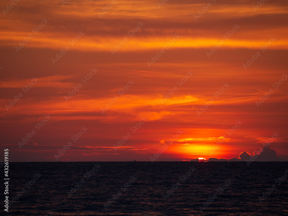 sunrise bring hope. and sunset bring the peace. most of beautiful and relaxing mediations place. dramatic red color of sunlight at the horizon. wonderful sky at the sea. clouds covered round sun