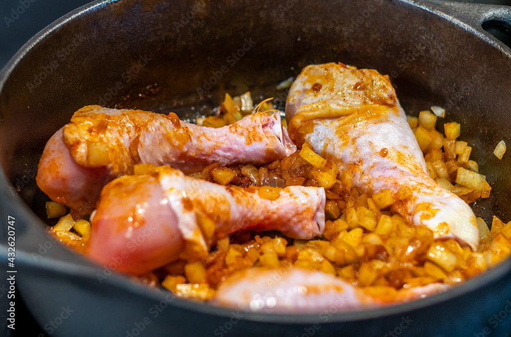 Chicken legs with roasted onion in the iron pan. Dinner or lunch cooking, detail view. Chicken legs with roasted onion in the iron pan. Dinner or lunch cooking, detail view.