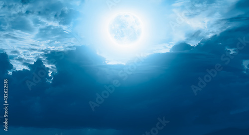 Night sky with blue full moon in the clouds  Elements of this image furnished by NASA