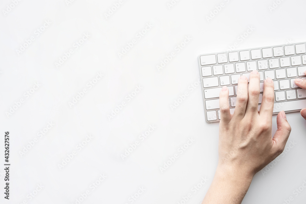 Man is typing on laptop keyboard over white office desk table. Top view with copy space, flat lay. Man is typing on laptop keyboard over white office desk table. Top view with copy space, flat lay.