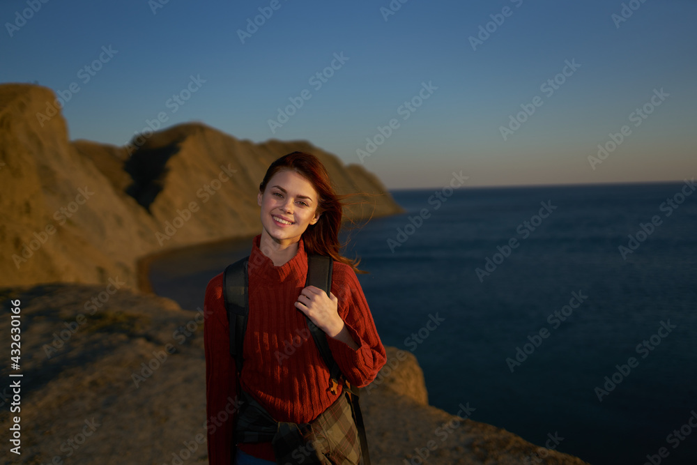 cheerful woman with backpack on nature rocky mountains horizon ocean freedom