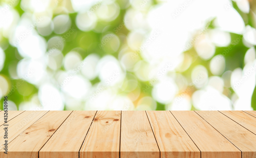 Wood floor with blurred trees of nature park background and summer season, product display montage Wood floor with blurred trees of nature park background and summer season, product display montage