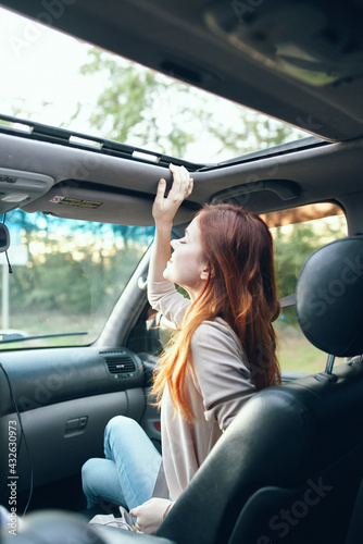 woman fellow traveler in a car salon in the front seat design open window nature