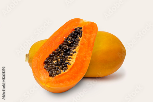 Ripe papaya fruit with half papaya isolated on white background.