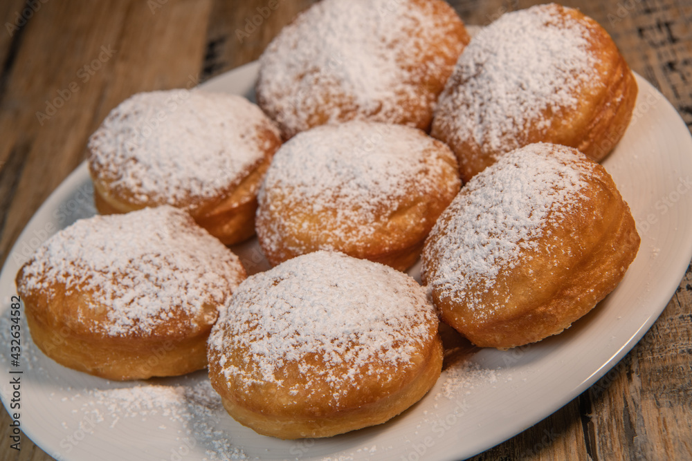 Freshly cooked Apricot jam doughnuts, referred to as jelly doughnuts, donuts in the US, The doughnuts have been fried, injected with a generous amount of jelly, jam and then dipped in caster sugar