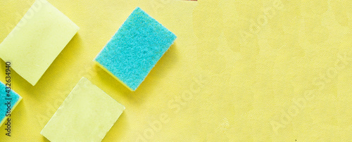 Several bright yellow sponges on yellow background.