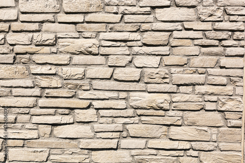Off white brick stone wall  different size bricks  textured 