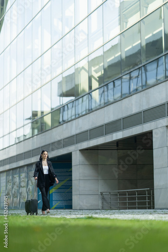 Businesswoman is walking with her bag