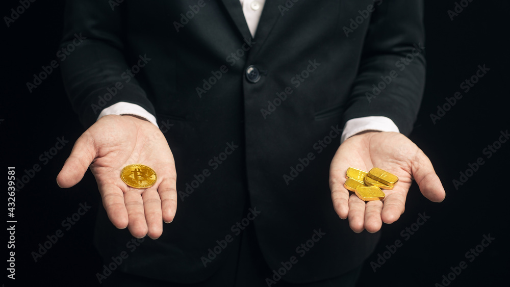 Fototapeta premium Businessman compare between cryptocurrency bitcoin coin with gold bar on hand. Cryptocurrency alternative finance and investment concept.