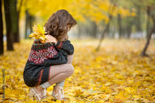 Autumn sadness concept. Woman walking in autumn park