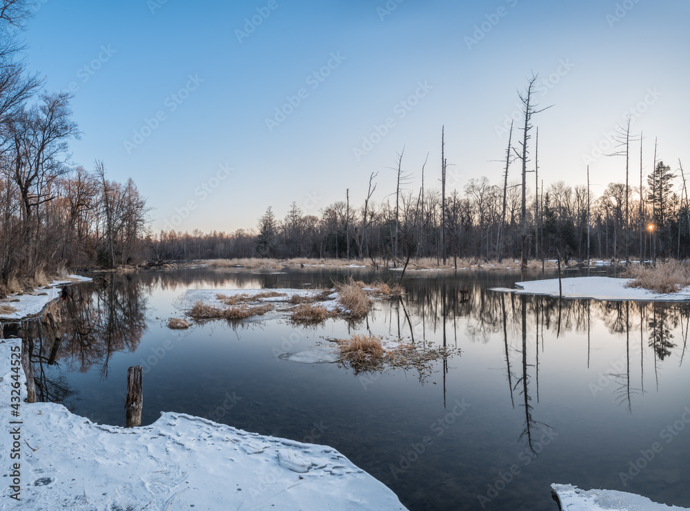 Snow and trees and rivers under the setting sun in Changbai Mountain, Jilin, China in winter 