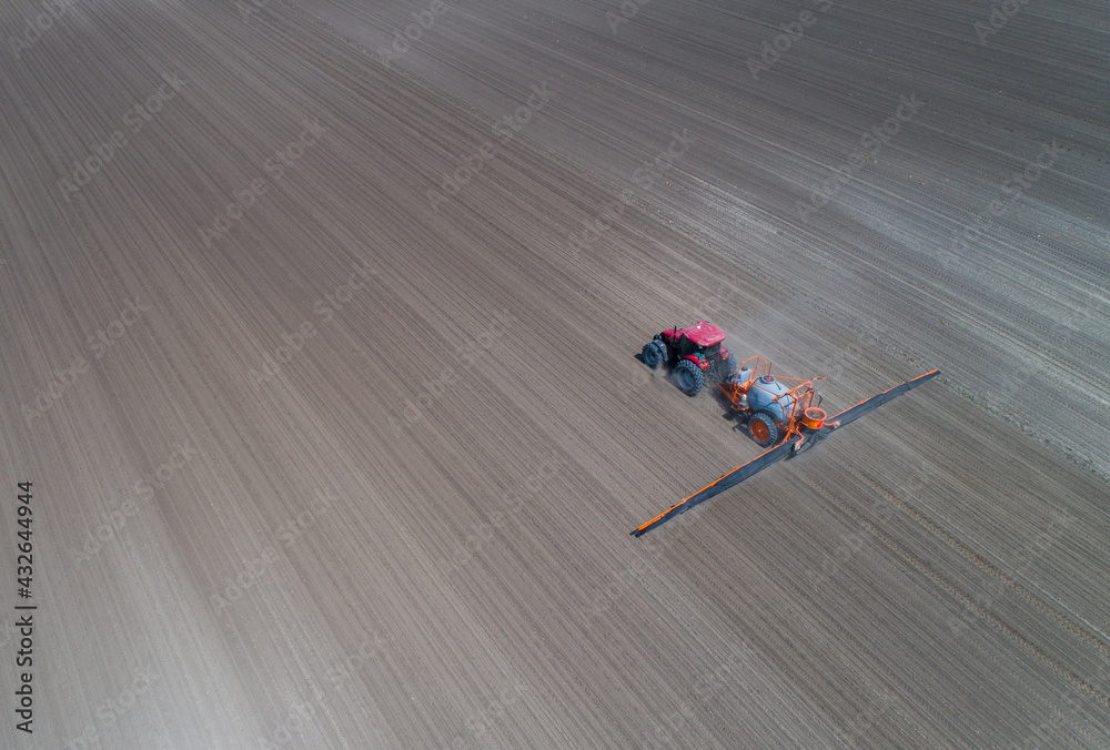 Aerial view of tractor spraying field