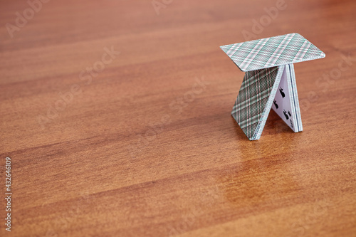 The house of cards is built on the table. The concept of not a reliable building. photo