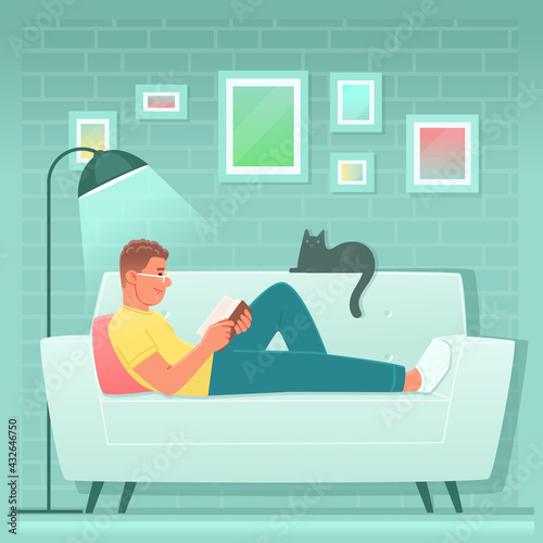 Happy man is reading a book while lying on the couch at home. Guy is a fan of literature or a student preparing for exams