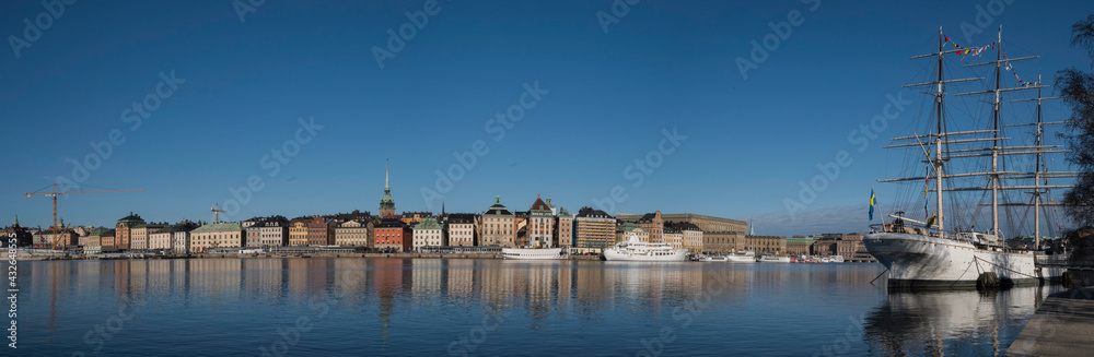 Morning spring view in the Stockholm harbor with boats and the old town Gamla Stan