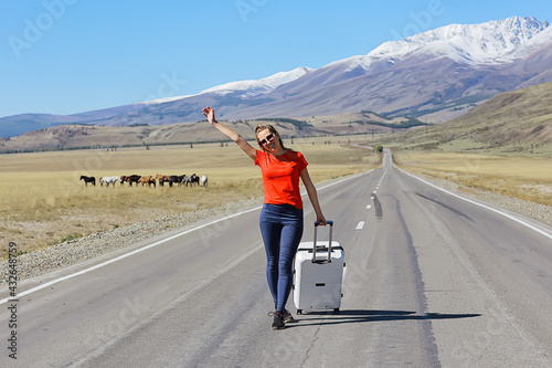 sexy girl in dress with suitcase on the highway  summer travel freedom  woman tourist