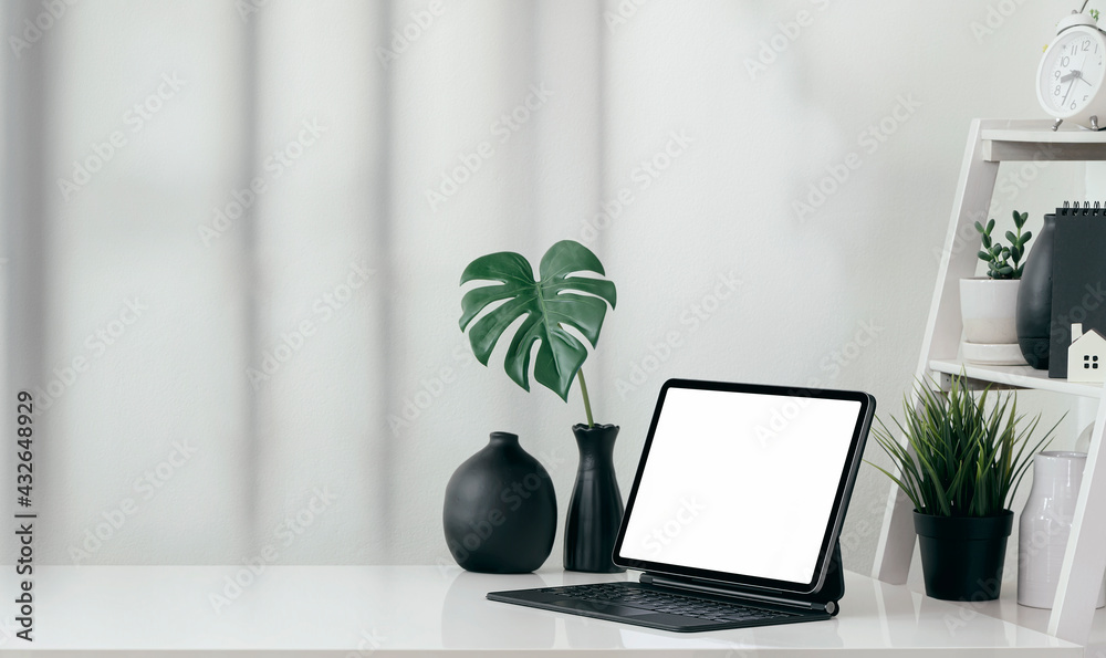 Fototapeta premium portable office desk with mockup computer devices, supplies and decorations on white table.