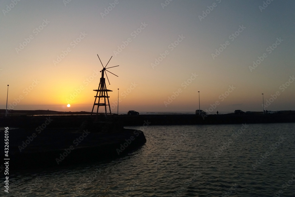 Backlight of a windmill at dusk