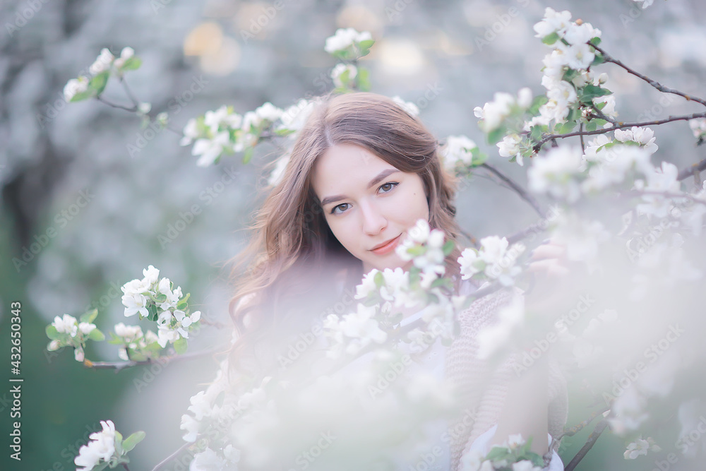 springtime fashion portrait of a young girl in a blooming cherry garden, tenderness of the morning springtime fashion portrait of a young girl in a blooming cherry garden, tenderness of the morning