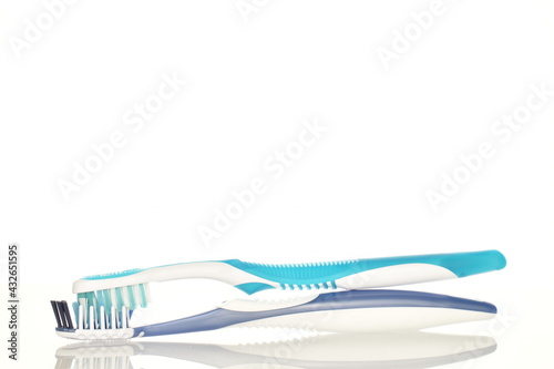 Two toothbrushes, close-up, isolated on white.
