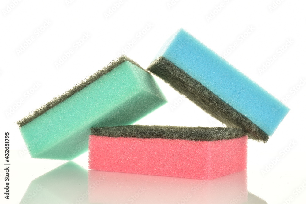 Three colored foam sponges, close-up, isolated on white. Three colored foam sponges, close-up, isolated on white.