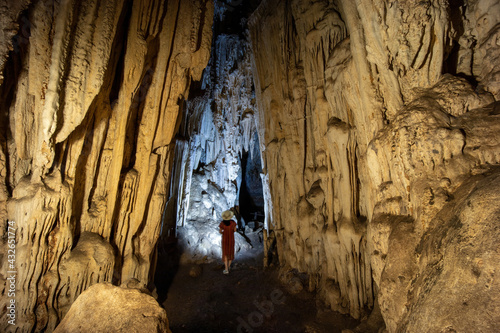 Beautiful nature of a cave, Magnificent entrance into the cave, Woman in cave