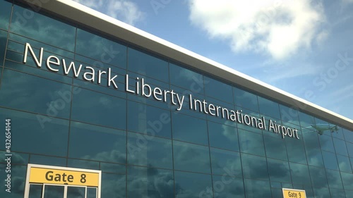 Commercial plane take off reflecting in the windows with Newark Liberty International Airport text photo