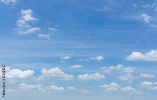 Beautiful white fluffy clouds on vivid blue sky in day light