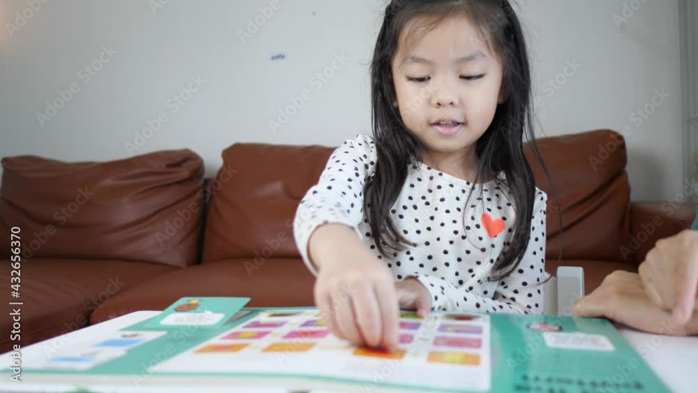 Smart Asian child girl happily reading book Smart Asian child girl happily reading book