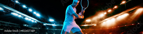 Tennis player with racket in white t-shirt. Man athlete playing on grand arena with tennis courts. © Mike Orlov