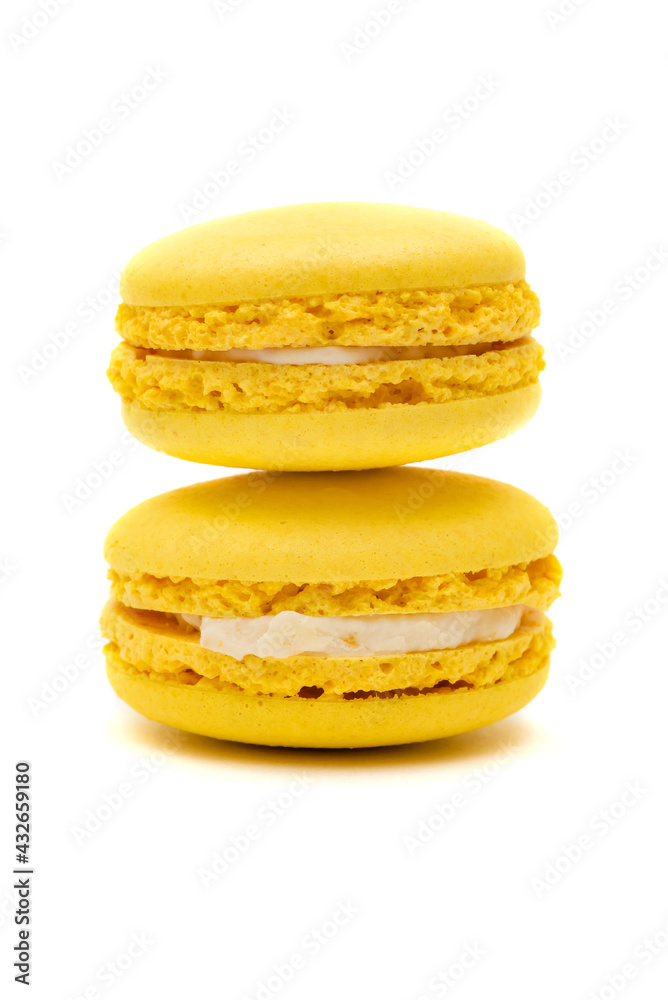 two yellow macaron cakes on a white background two yellow macaron cakes on a white background