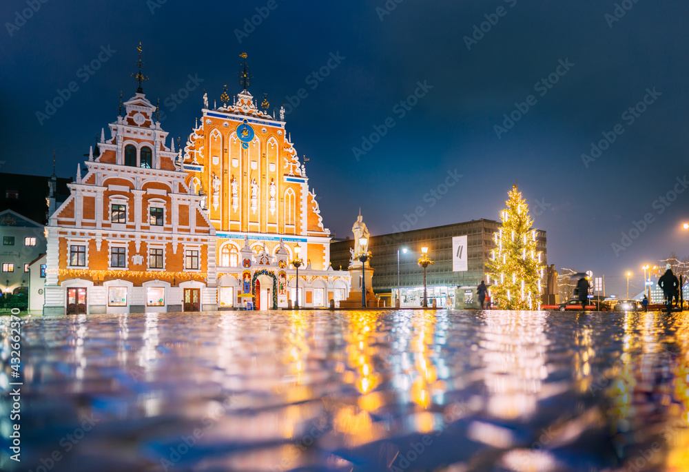 Riga, Latvia. Town Hall Square, Popular Place With Famous Landmarks On It In Night Illumination In Winter Twilight. Winter New Year Christmas Holiday Season