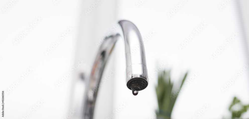 Obraz premium Kitchen tap isolated on bright background. Water saving solutions.