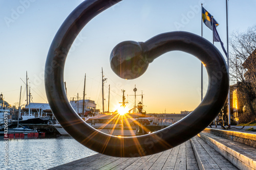 Sunset through special handle of fence on island in center of Stockholm