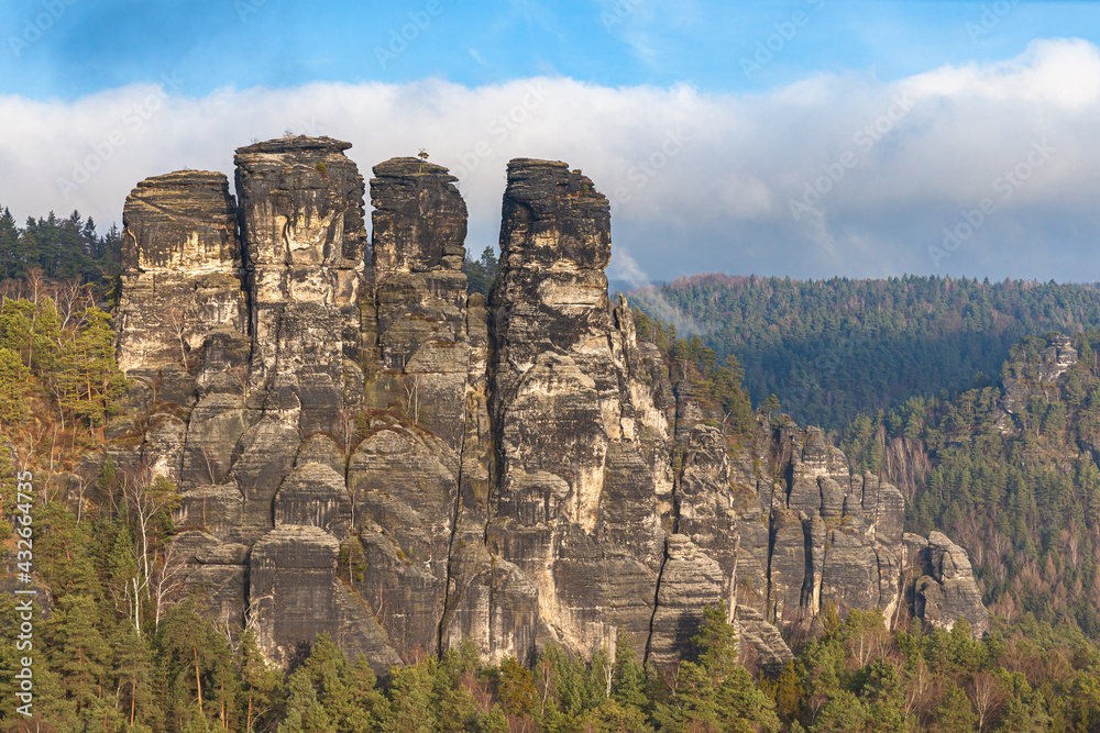 Beautiful panorama view of sandstone mountains in Saxon Switzerland National Park with Gansfelsen in foreground from Bastei bridge on a sunny day, Saxony, Germany