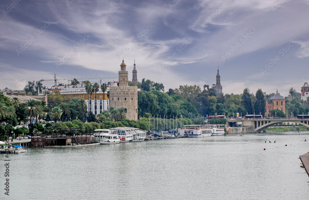 Panoramic view of the city of Seville with the Guadalquivir river and the Torre del Oro in the foreground, Andalusia, Spain