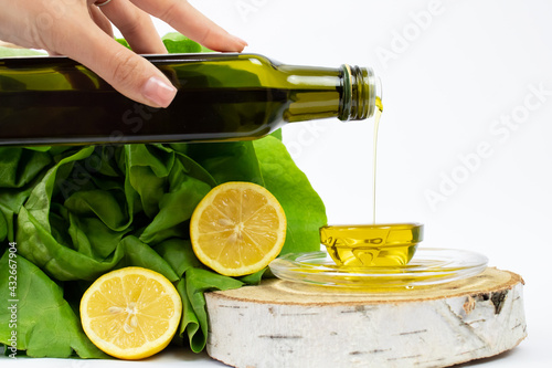 Konstfotografi Closeup shot of olive oil being poured into a plate near salad ingredients