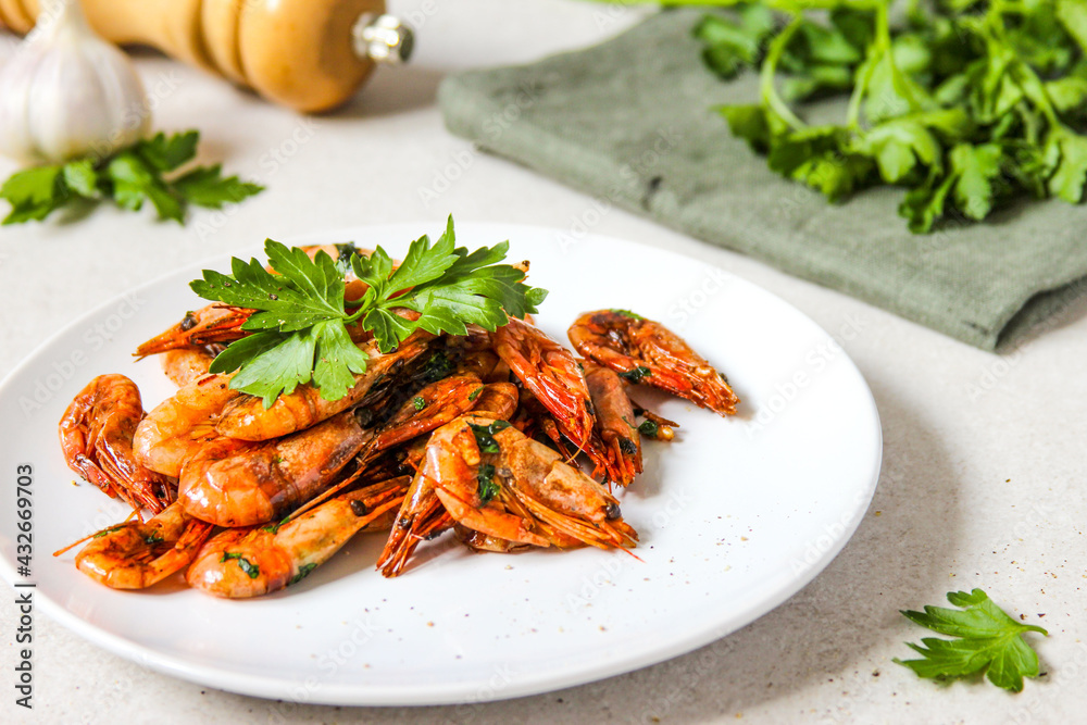 Grilled shrimps with garlic, parsley and black pepper on the white background. Grilled shrimps with garlic, parsley and black pepper on the white background.