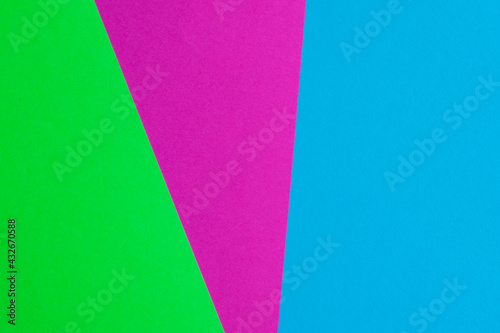 Bright paper background consisting of three colors: pink, green and blue