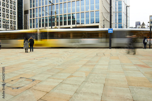 Long exposure tram in daylight Manchester St Peters Square