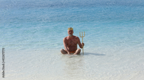 a man with a crown on the shore of a tropical island