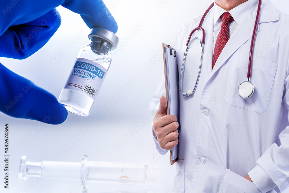 Fototapeta premium Concept fight against virus covid-19 corona virus, doctor with a stethoscope on shoulder holding syringe and COVID-19 vaccine adults, Concept: diseases, medical care, science.