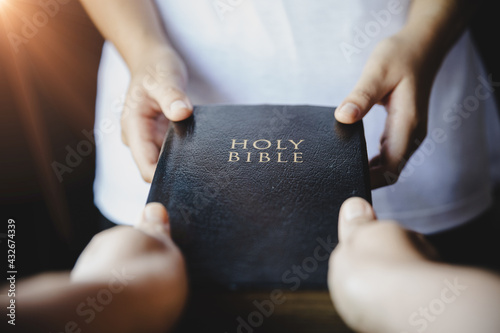 Woman hands giving Bible