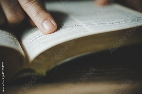 woman's hands while reading the Bible. photo