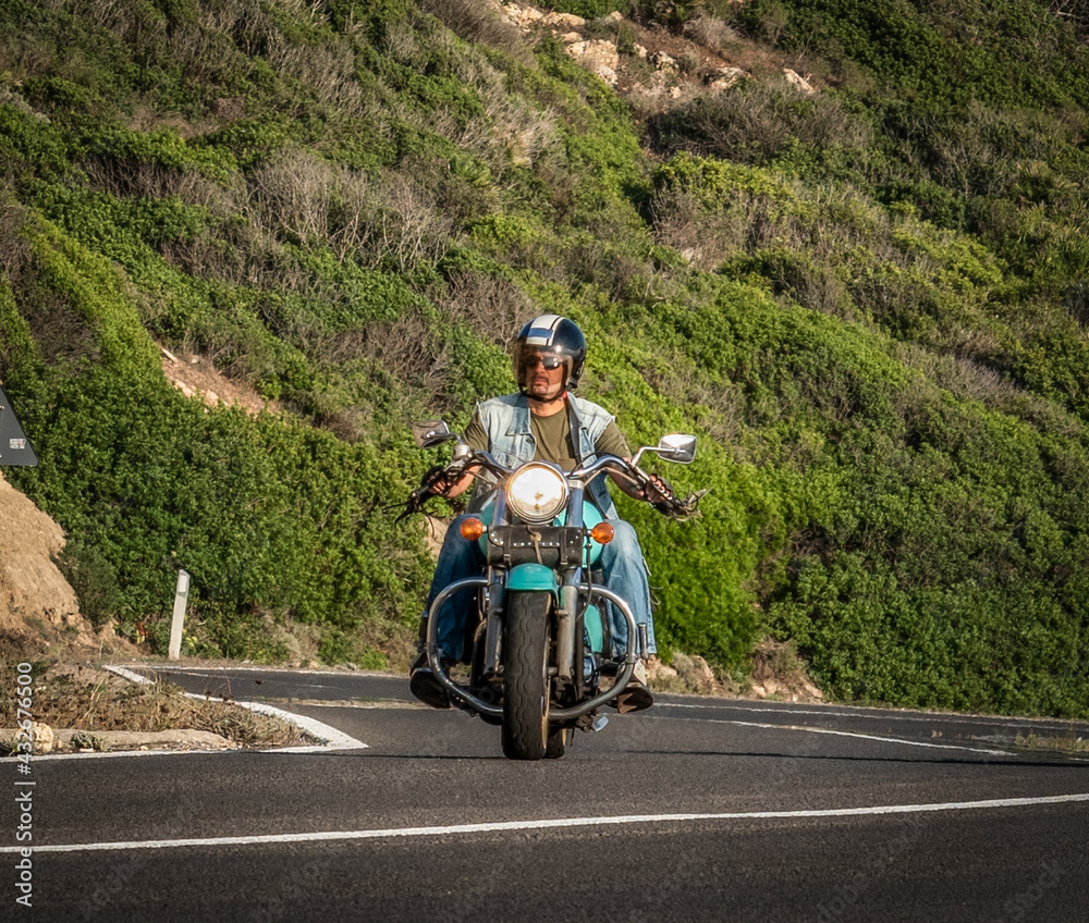 Front view of a biker on a classic motorcycle Front view of a biker on a classic motorcycle
